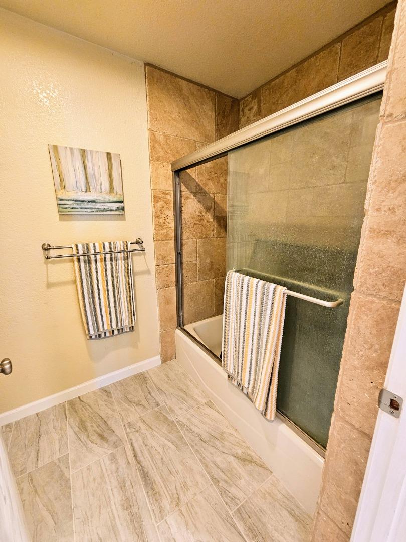 40 Shepherds Knoll Road, Unit 40 Monterey, CA 93940 - Photo 42 of 52 a bedroom with a bed and wooden floor