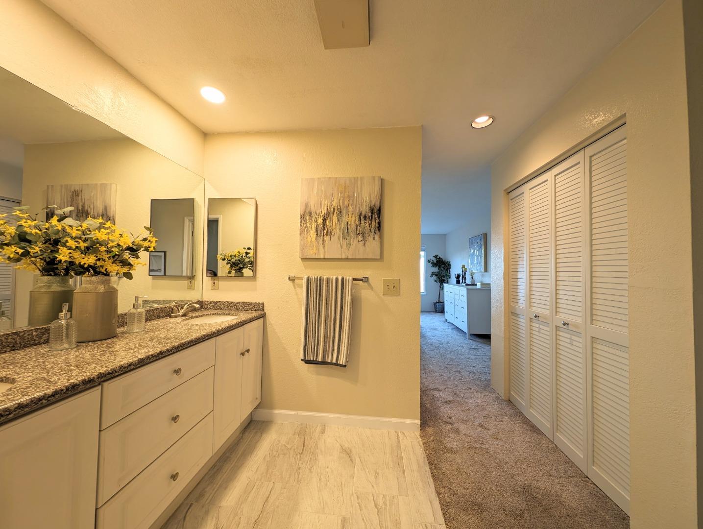40 Shepherds Knoll Road, Unit 40 Monterey, CA 93940 - Photo 46 of 52 a bathroom with a granite countertop sink a mirror and a shower