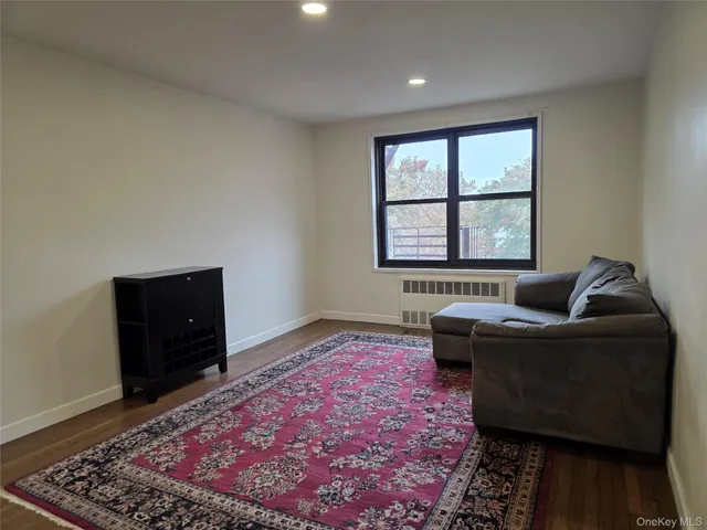 a living room with a couch and a rug