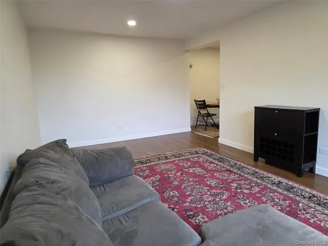 a living room with a couch and a dresser