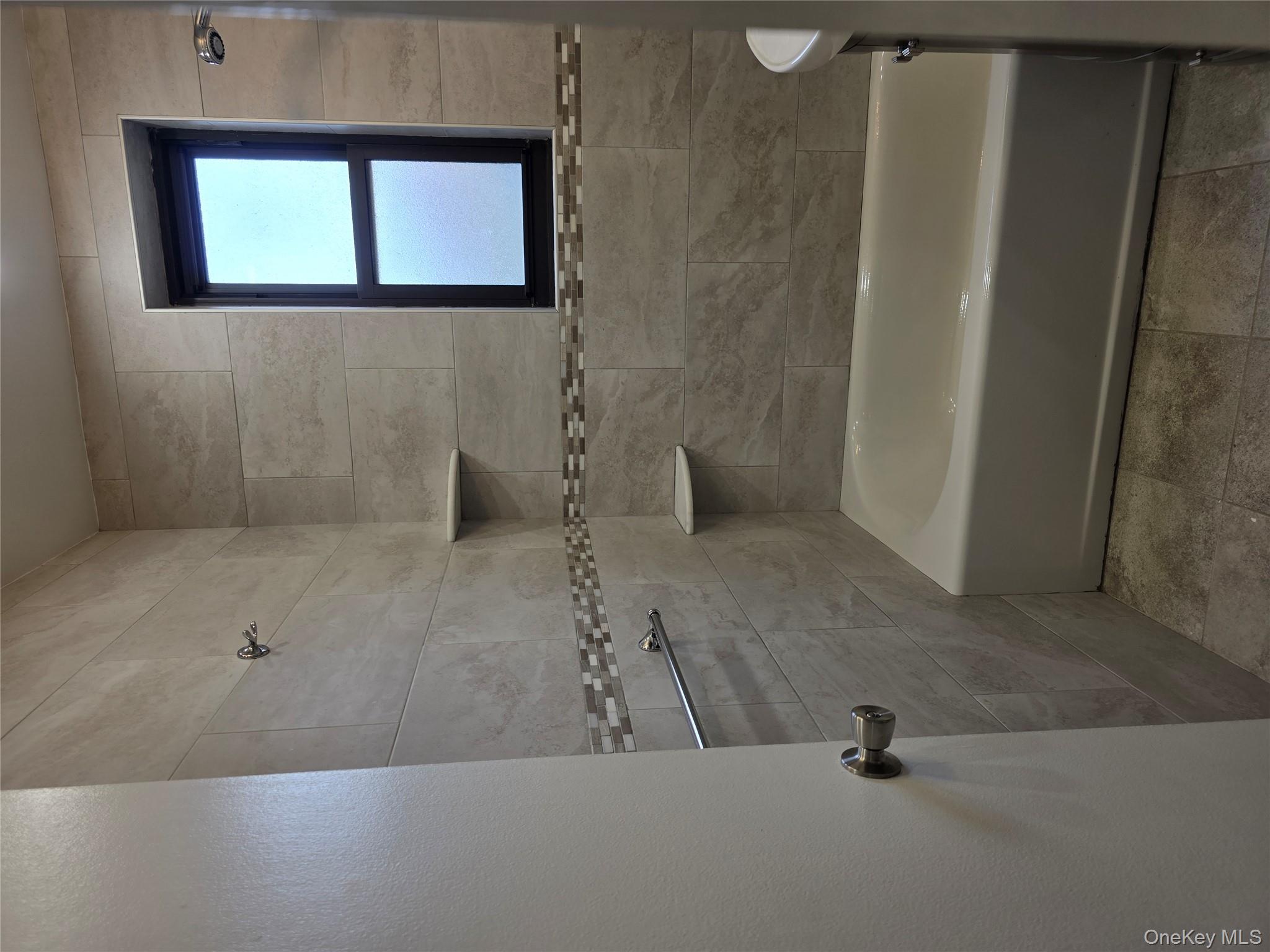 84-01 Main Street, Unit 506 Queens, NY 11435 - Photo 13 of 25 a bathroom with a bathtub