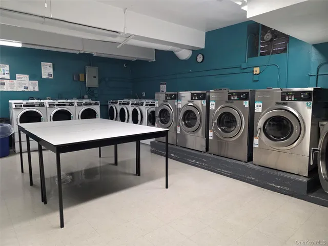 a utility room with dryer washer and stair