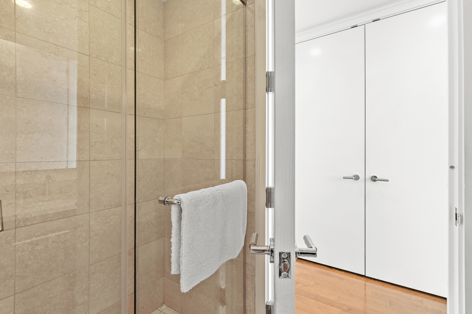 401 North Wabash Avenue, Unit 66A Chicago, IL 60611 - Photo 16 of 26 a bathroom with a shower and a glass door