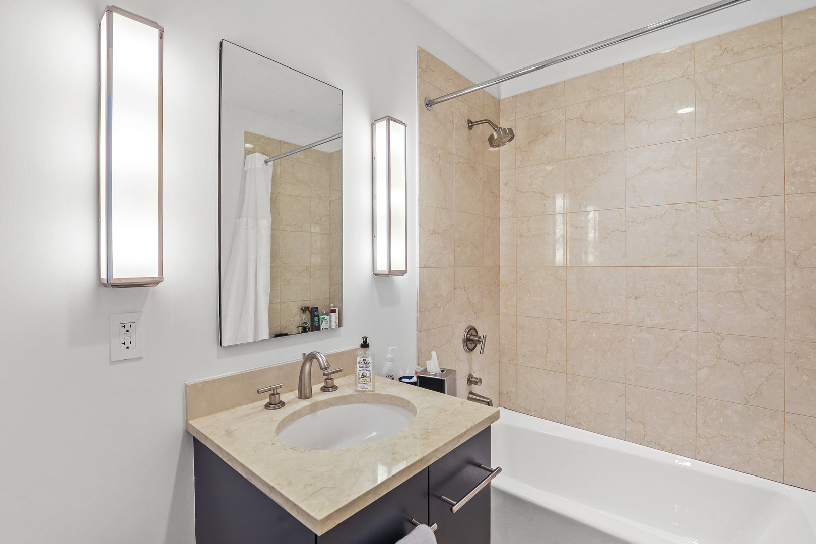 401 North Wabash Avenue, Unit 66A Chicago, IL 60611 - Photo 17 of 26 a bathroom with a sink vanity tub and shower