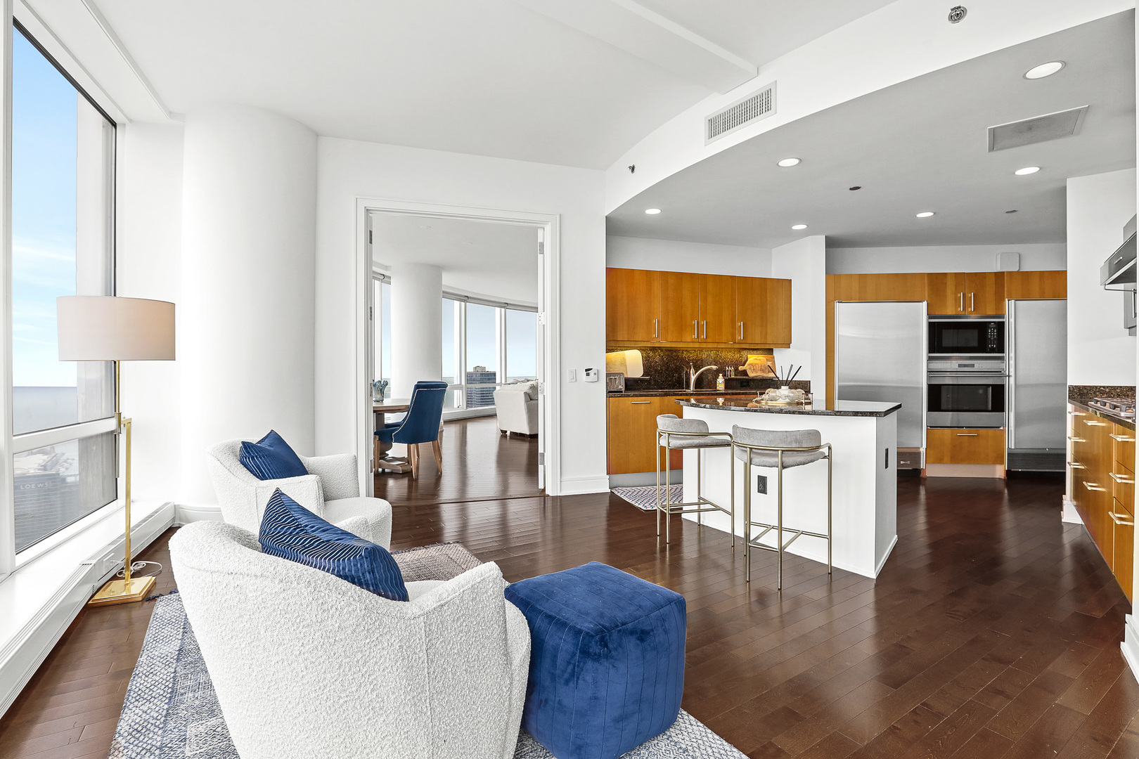 401 North Wabash Avenue, Unit 66A Chicago, IL 60611 - Photo 10 of 26 a living room with couches kitchen view and a large window