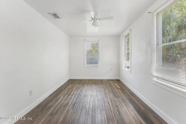 wooden floor in an empty room with a window