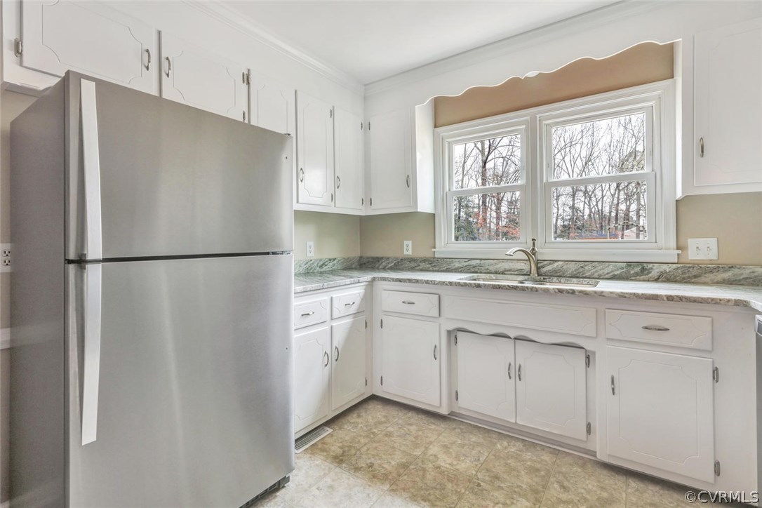 9817 Brenspark Road Chesterfield, VA 23832 - Photo 8 of 17 a kitchen with stainless steel appliances granite countertop a refrigerator sink and cabinets