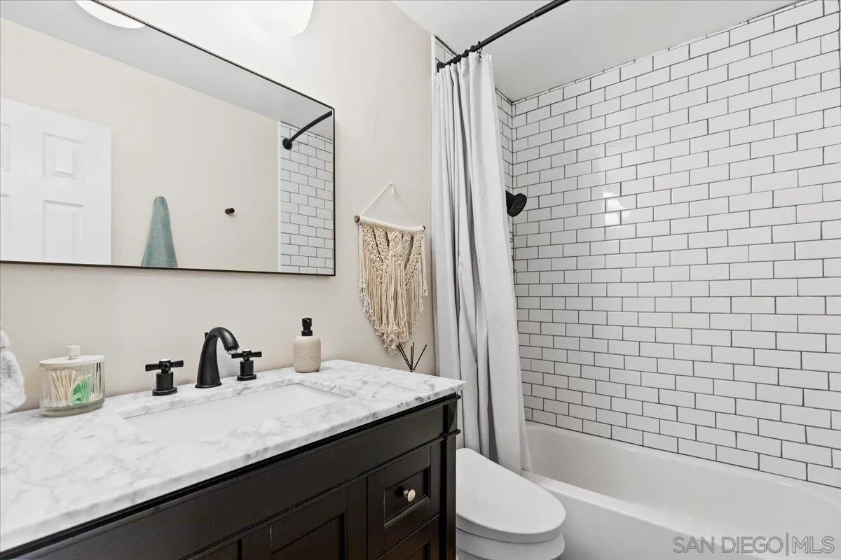 12243 Buckskin Trail Poway, CA 92064 - Photo 37 of 41 a bathroom with a granite countertop sink a toilet and shower