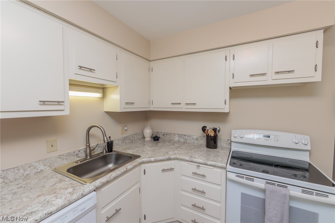 1750 Wagar Road, Unit 206 Rocky River, OH 44116 - Photo 18 of 33 Kitchen featuring white appliances, light countertops, and white cabinetry