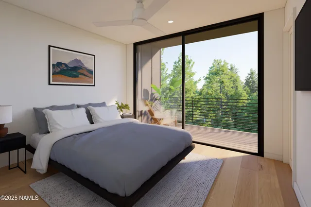 a bedroom with a large bed and a large window