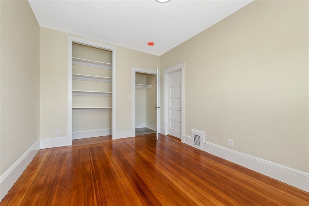 44 Brackett Street, Unit 3 Boston, MA 02135 - Photo 11 of 28 a view of an empty room with wooden floor