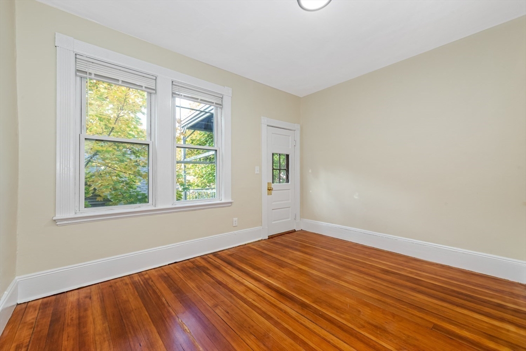 44 Brackett Street, Unit 3 Boston, MA 02135 - Photo 12 of 28 a view of an empty room with wooden floor and a window
