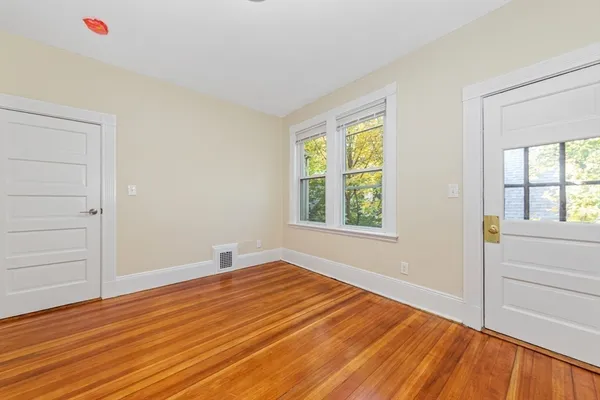 wooden floor in an empty room with a window