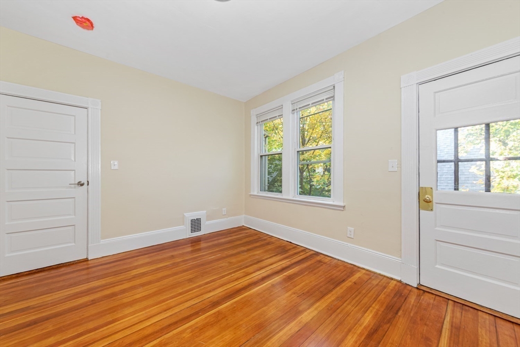 44 Brackett Street, Unit 3 Boston, MA 02135 - Photo 13 of 28 wooden floor in an empty room with a window