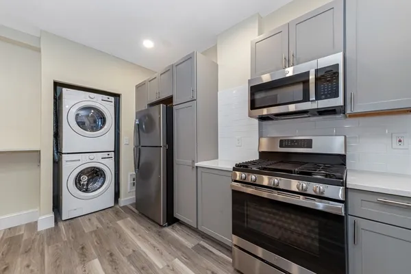 a kitchen with stainless steel appliances a stove a microwave and cabinets