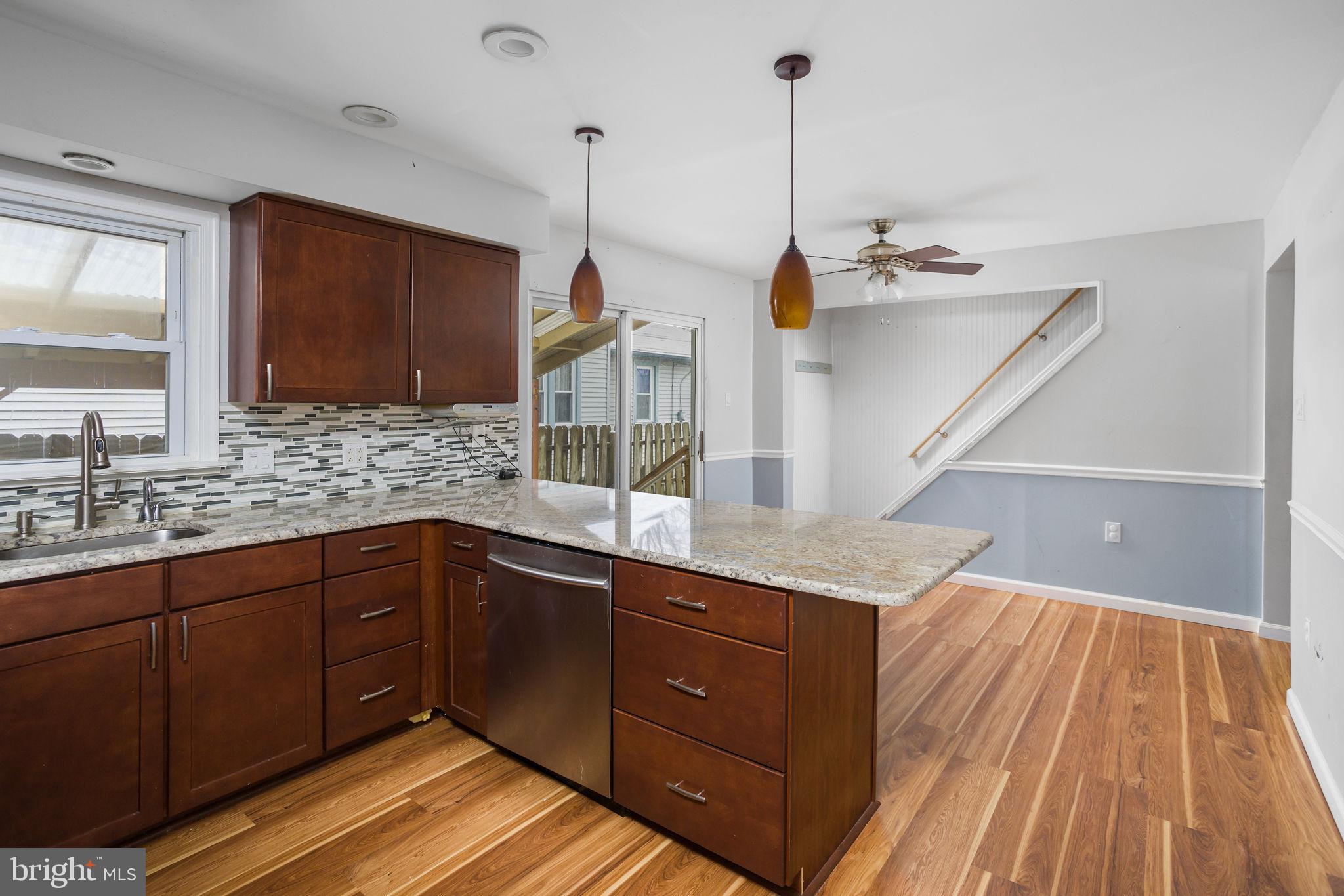 400 Reading Avenue Barrington, NJ 08007 - Photo 11 of 35 a kitchen with a sink and wooden floor
