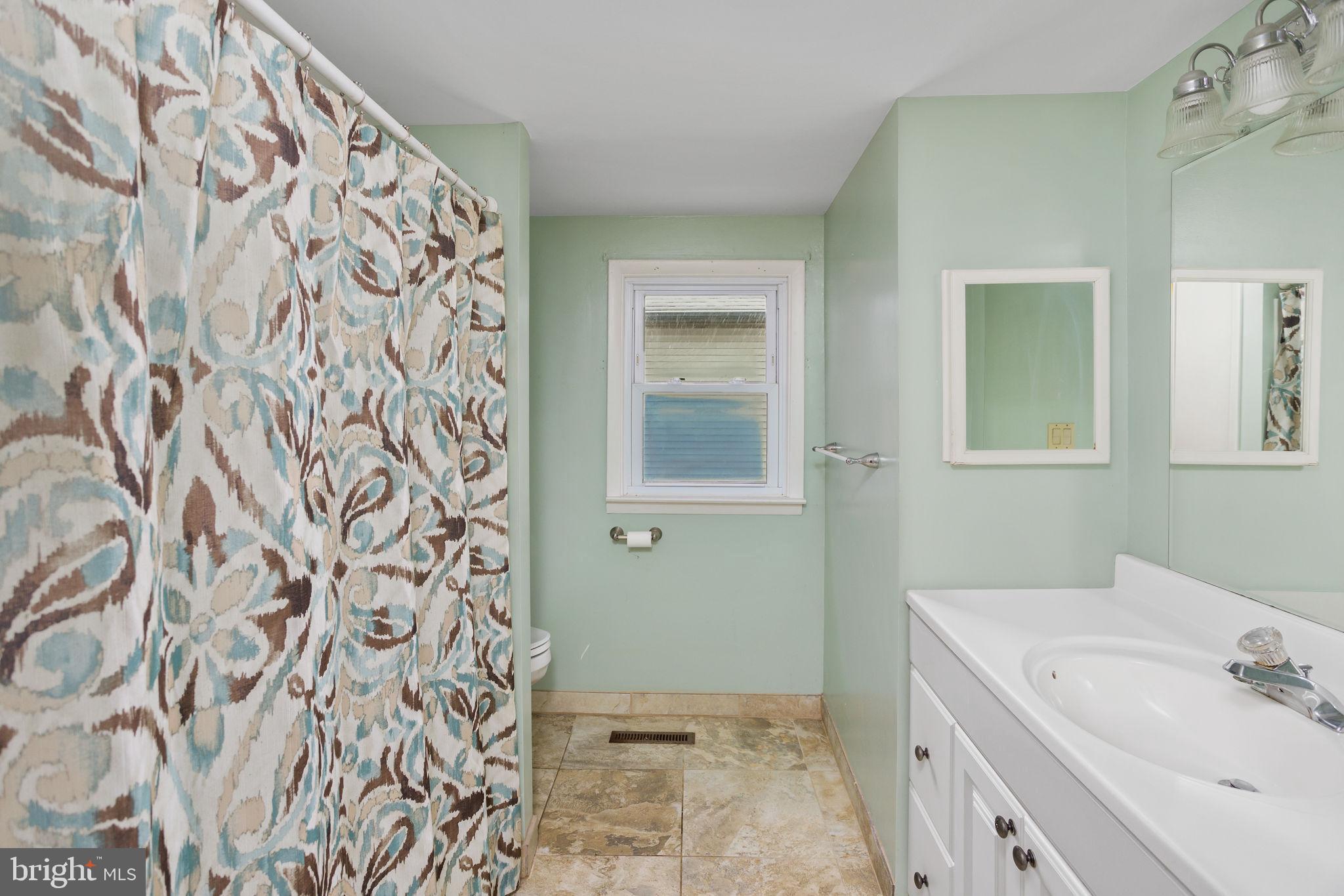 400 Reading Avenue Barrington, NJ 08007 - Photo 18 of 35 a bathroom with a sink and a mirror