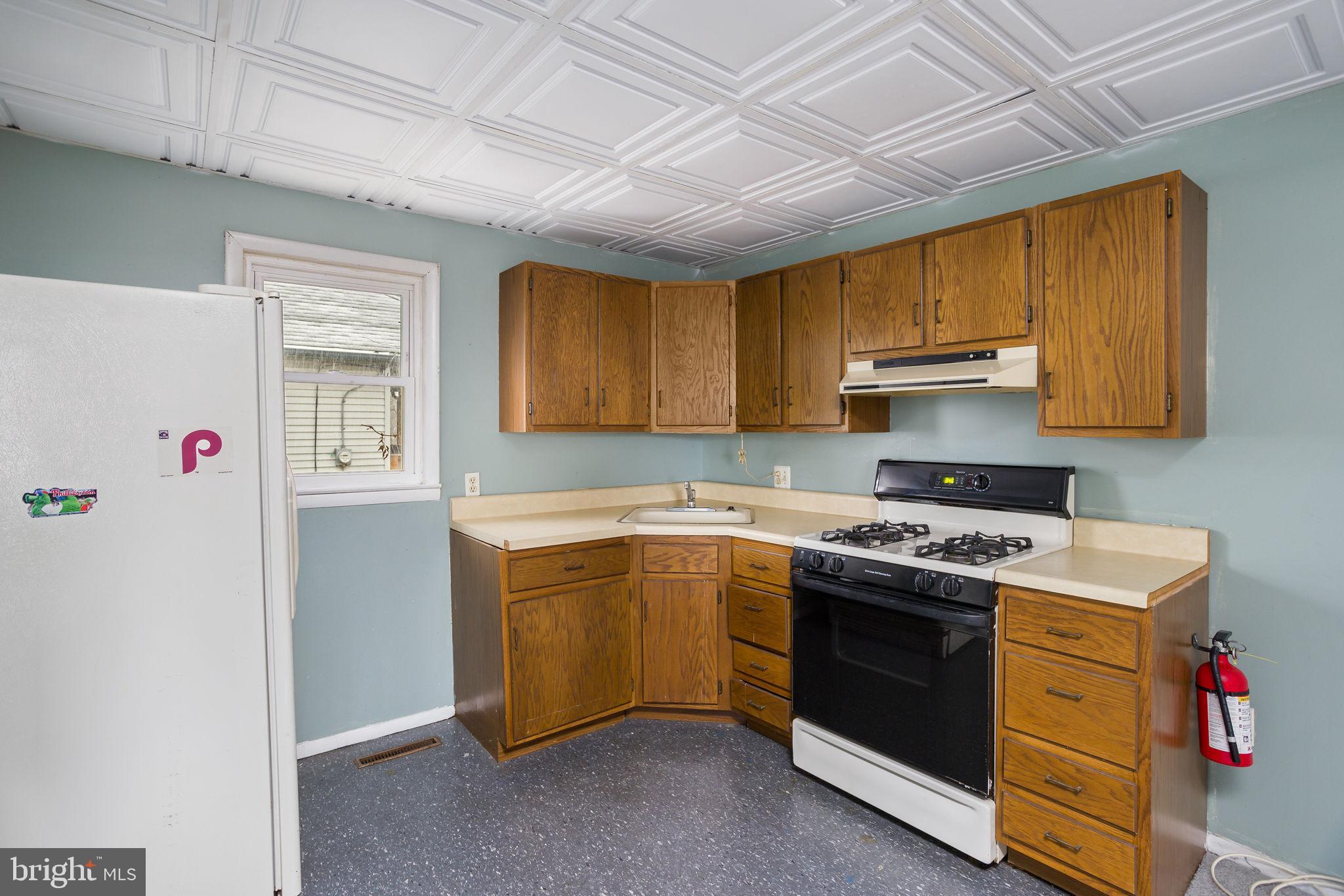 400 Reading Avenue Barrington, NJ 08007 - Photo 24 of 35 a kitchen with stainless steel appliances granite countertop a stove a sink and a refrigerator