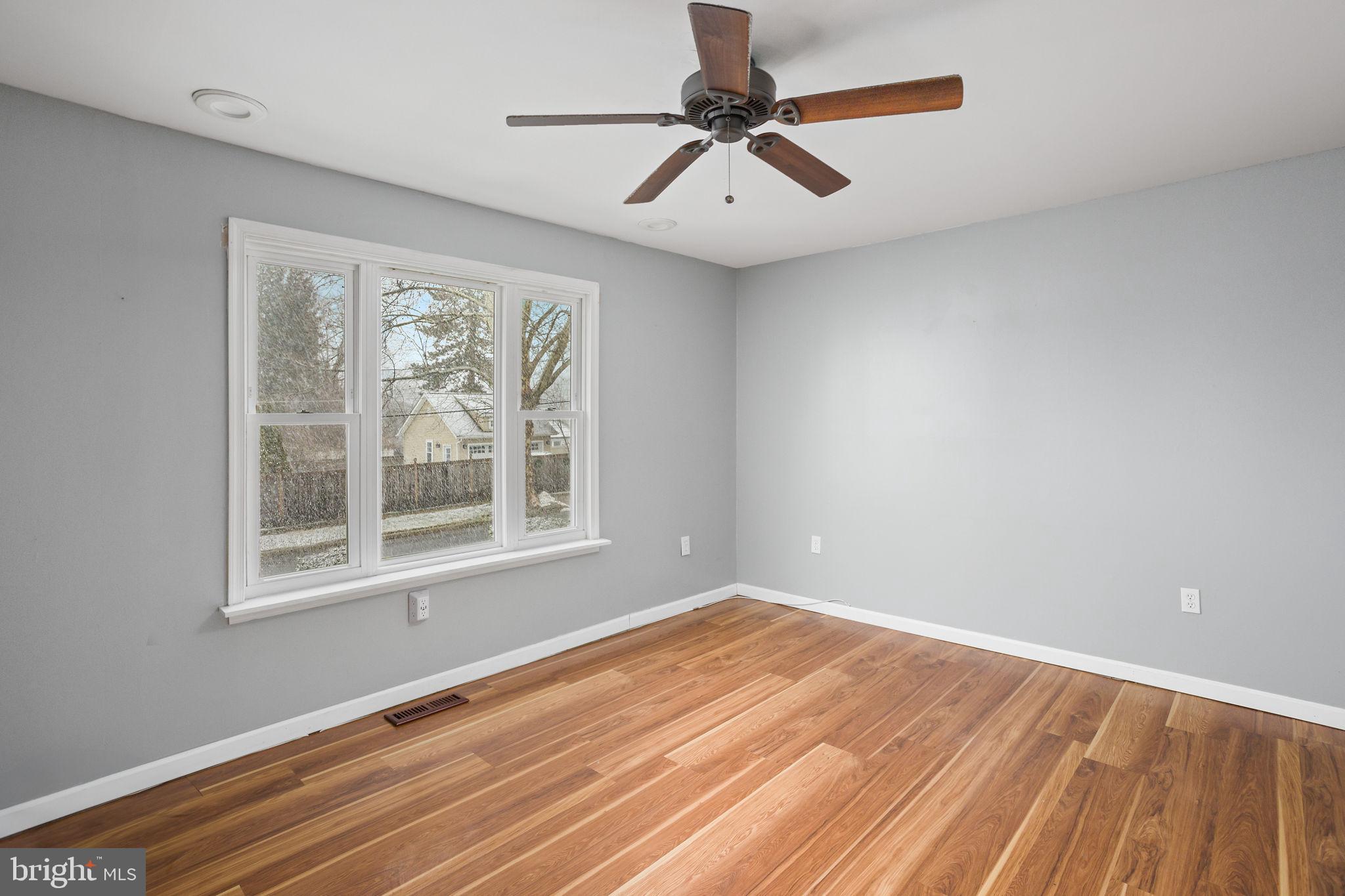 400 Reading Avenue Barrington, NJ 08007 - Photo 7 of 35 a view of an empty room with wooden floor and a window