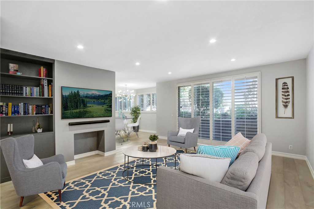 a living room with furniture a flat screen tv and a fireplace