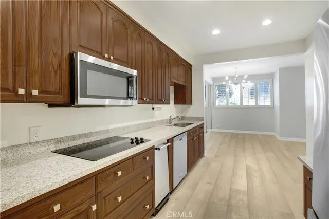 a kitchen with wooden cabinets and a stove top oven