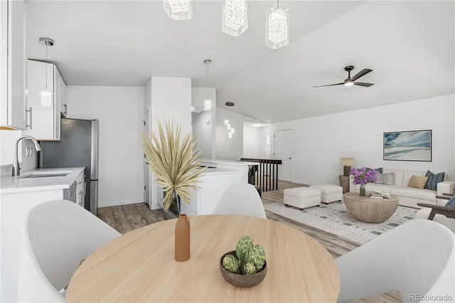 a view of a dining room with furniture and a chandelier