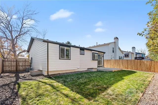 a view of backyard with swimming pool and trees in the background