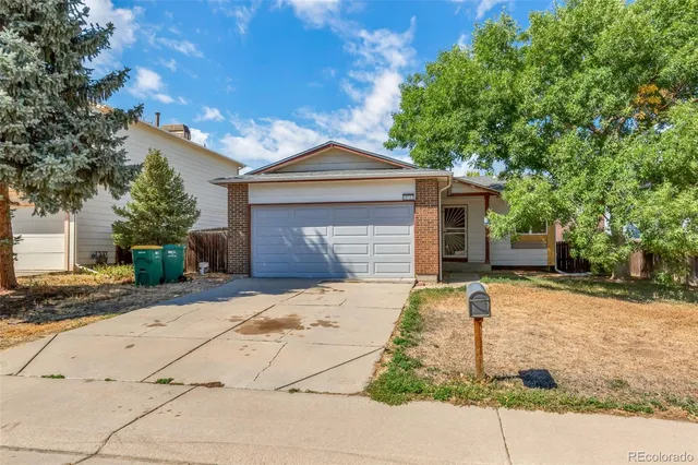 a kitchen with a refrigerator a sink and a window