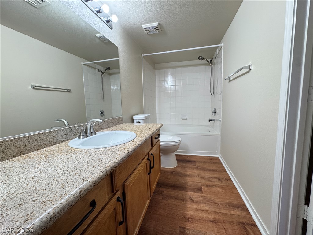 7255 West Sunset Road, Unit 2111 Las Vegas, NV 89113 - Photo 19 of 33 Laminate flooring graces this well-appointed bathroom featuring a single vanity with granite counters.