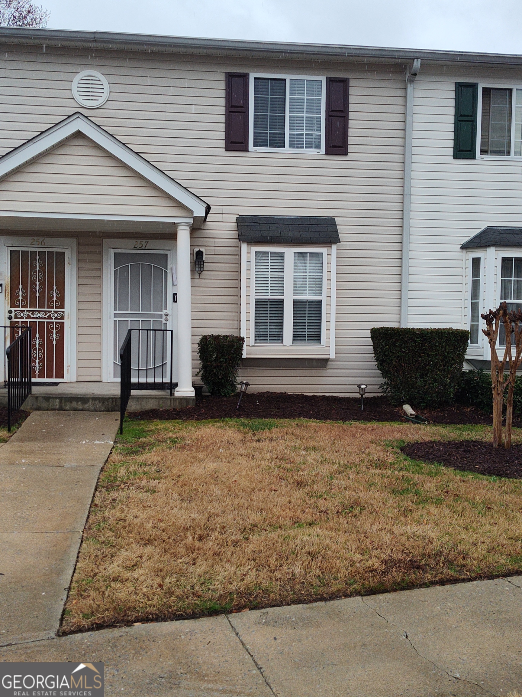 1625 Conley Road, Unit 257 Conley, GA 30288 - Photo 1 of 1 a front view of a house with garden