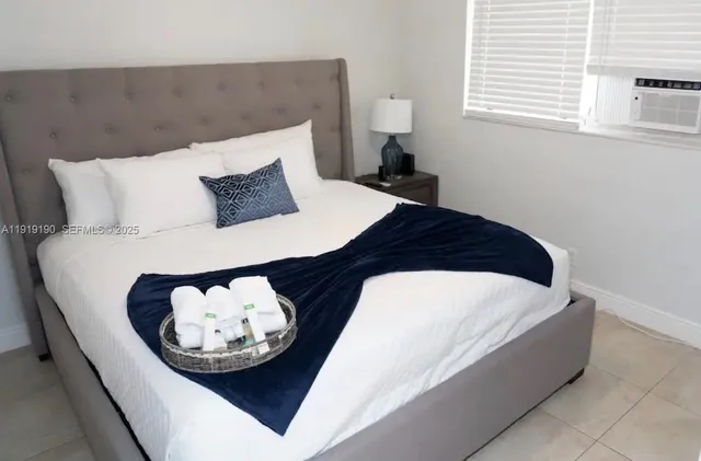 a bedroom with a bed and a night stand