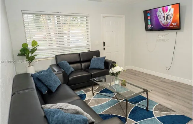 a living room with furniture and a potted plant