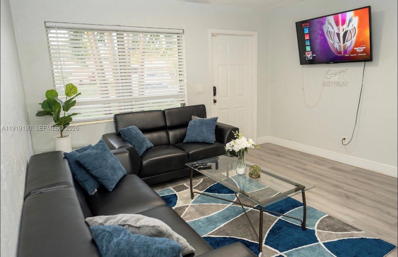 6512 Southwest 24th Street, Unit 1 Miramar, FL 33023 - Photo 2 of 15 a living room with furniture and a potted plant