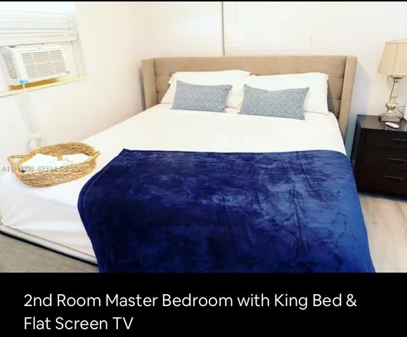 a bed sitting in a bedroom next to a wall