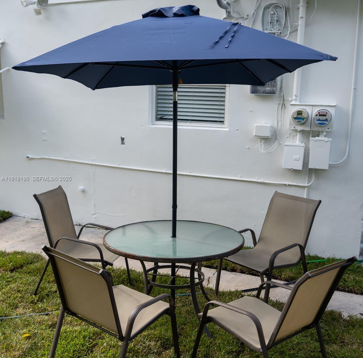 6512 Southwest 24th Street, Unit 1 Miramar, FL 33023 - Photo 10 of 15 a patio table and chairs with an umbrella