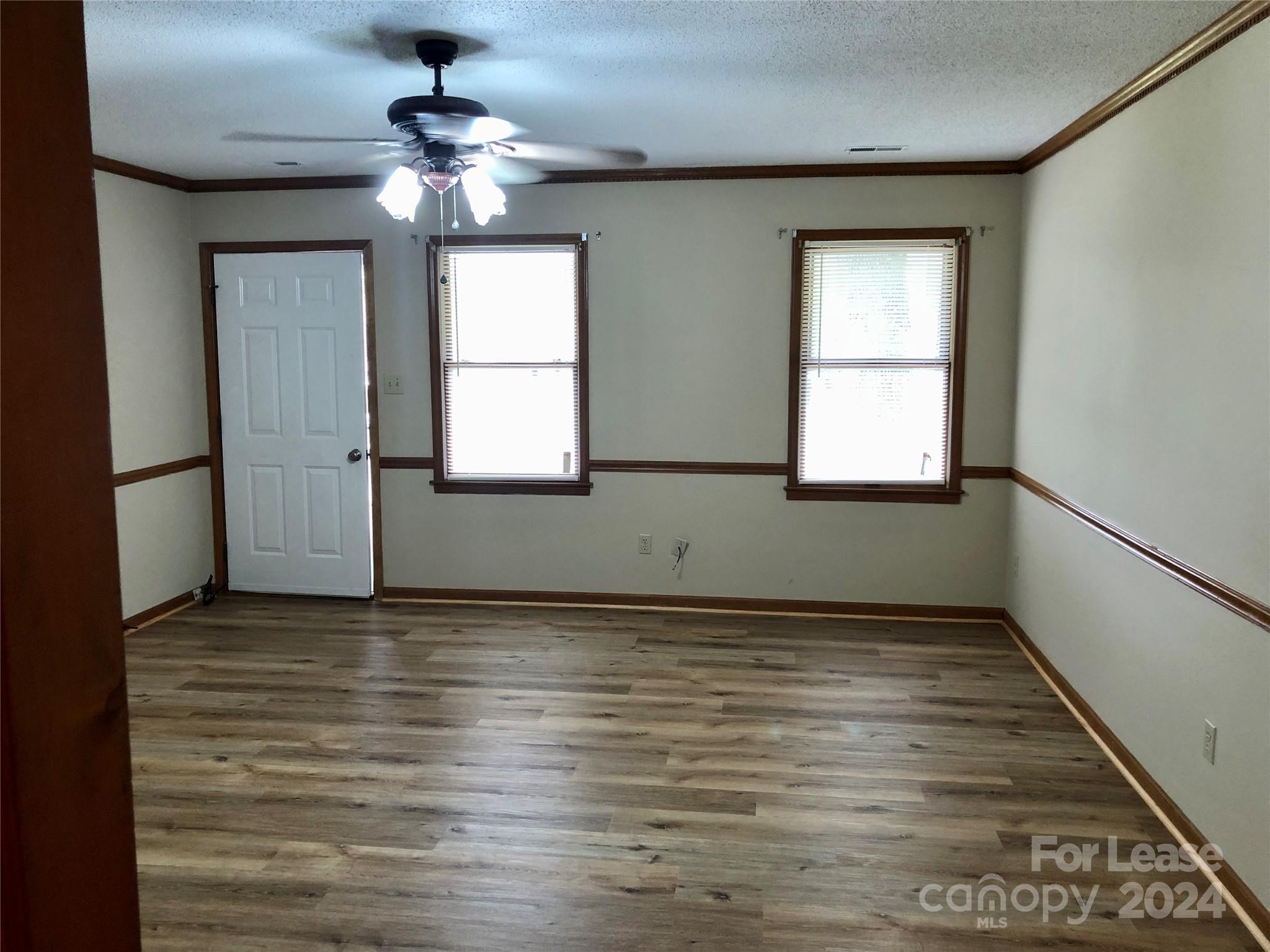 1637 Green Acres Road Lincolnton, NC 28092 - Photo 5 of 12 an empty room with wooden floor chandelier and windows