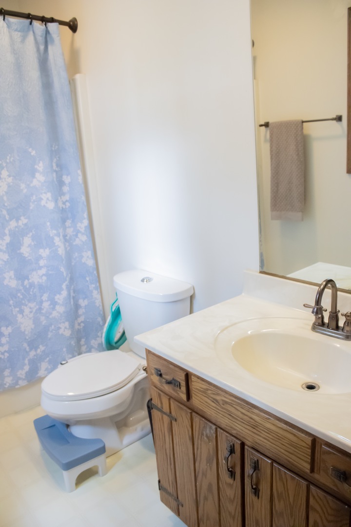 412 Spring Circle Urbana, IL 61802 - Photo 13 of 21 a bathroom with a sink a toilet and a mirror