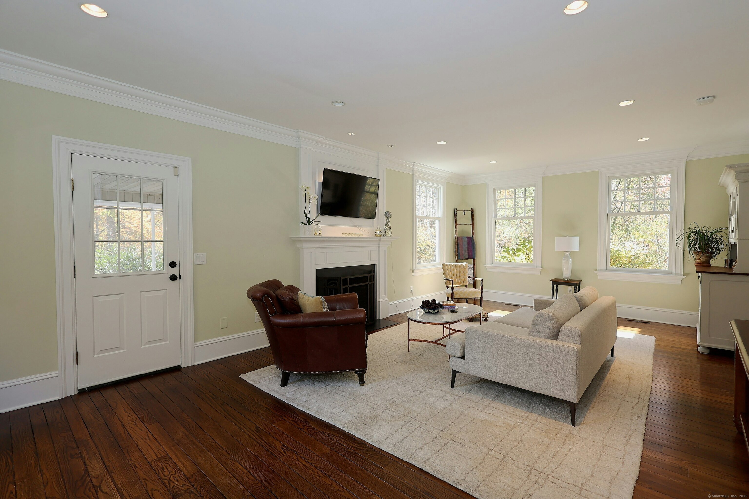 112 Middlebrook Farm Road Wilton, CT 06897 - Photo 13 of 40 a living room with furniture a fireplace and a flat screen tv