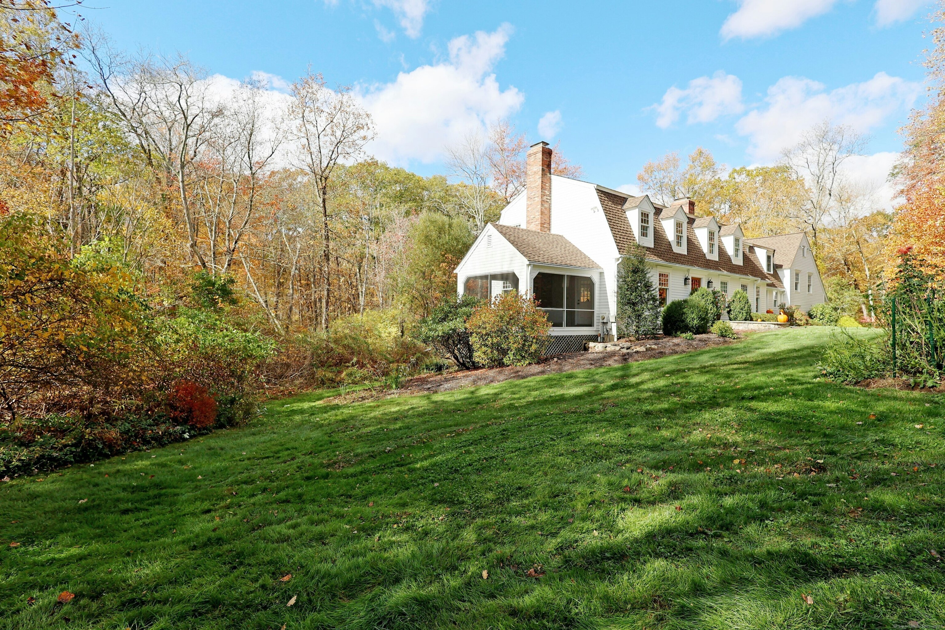 112 Middlebrook Farm Road Wilton, CT 06897 - Photo 2 of 40 a front view of a house with a yard