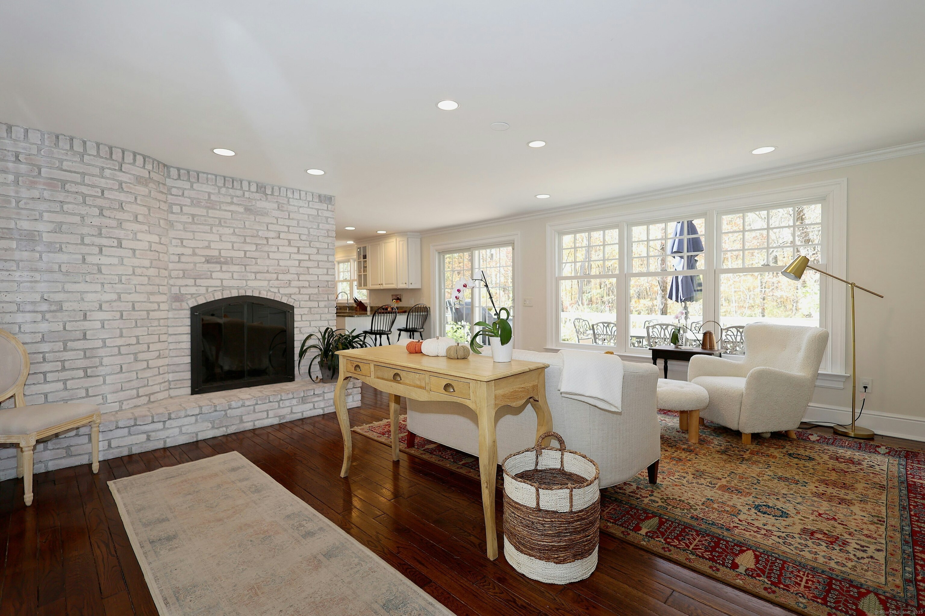 112 Middlebrook Farm Road Wilton, CT 06897 - Photo 21 of 40 a living room with fireplace furniture and a large window
