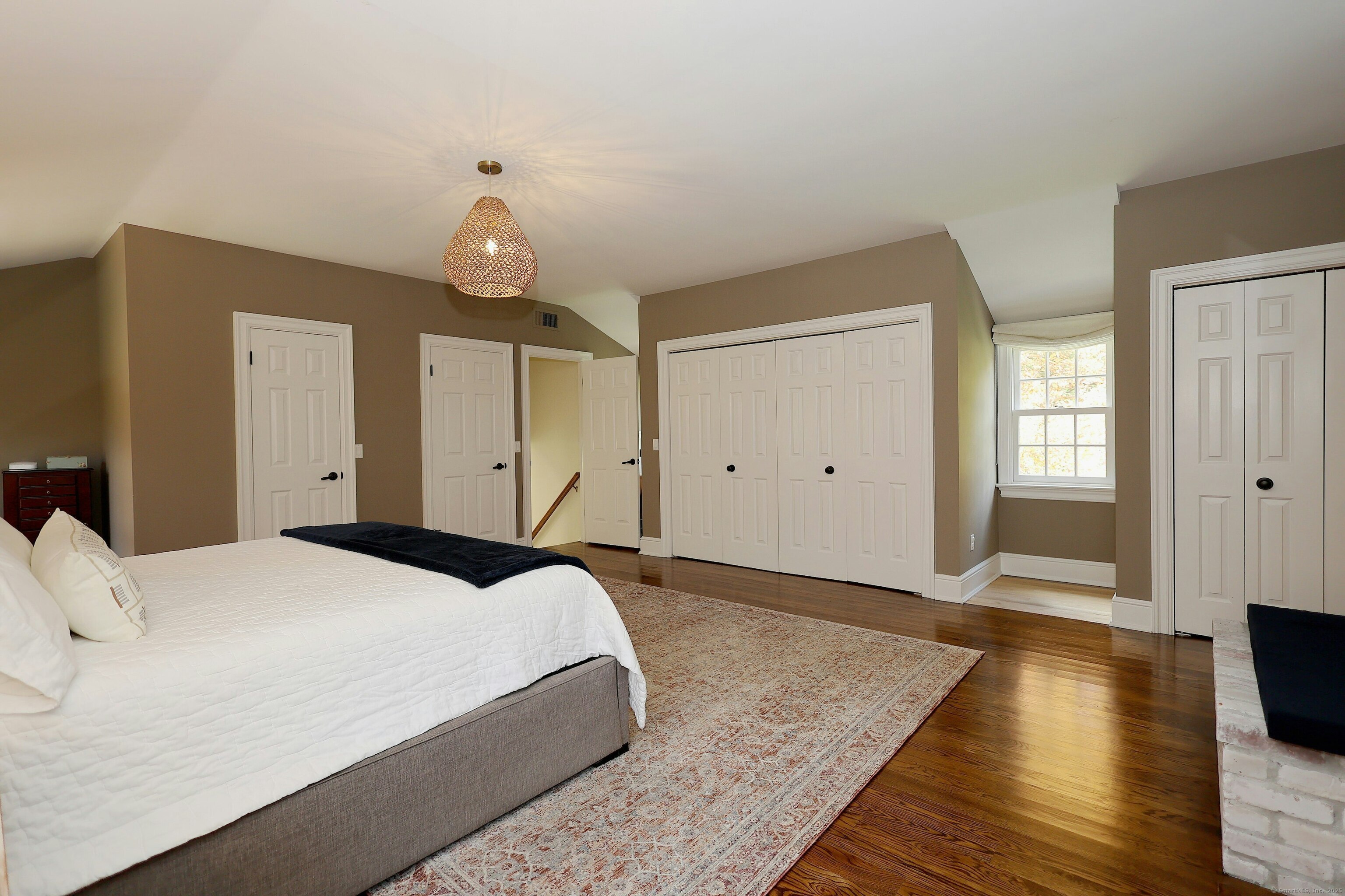 112 Middlebrook Farm Road Wilton, CT 06897 - Photo 31 of 40 a bedroom with a bed and wooden floor