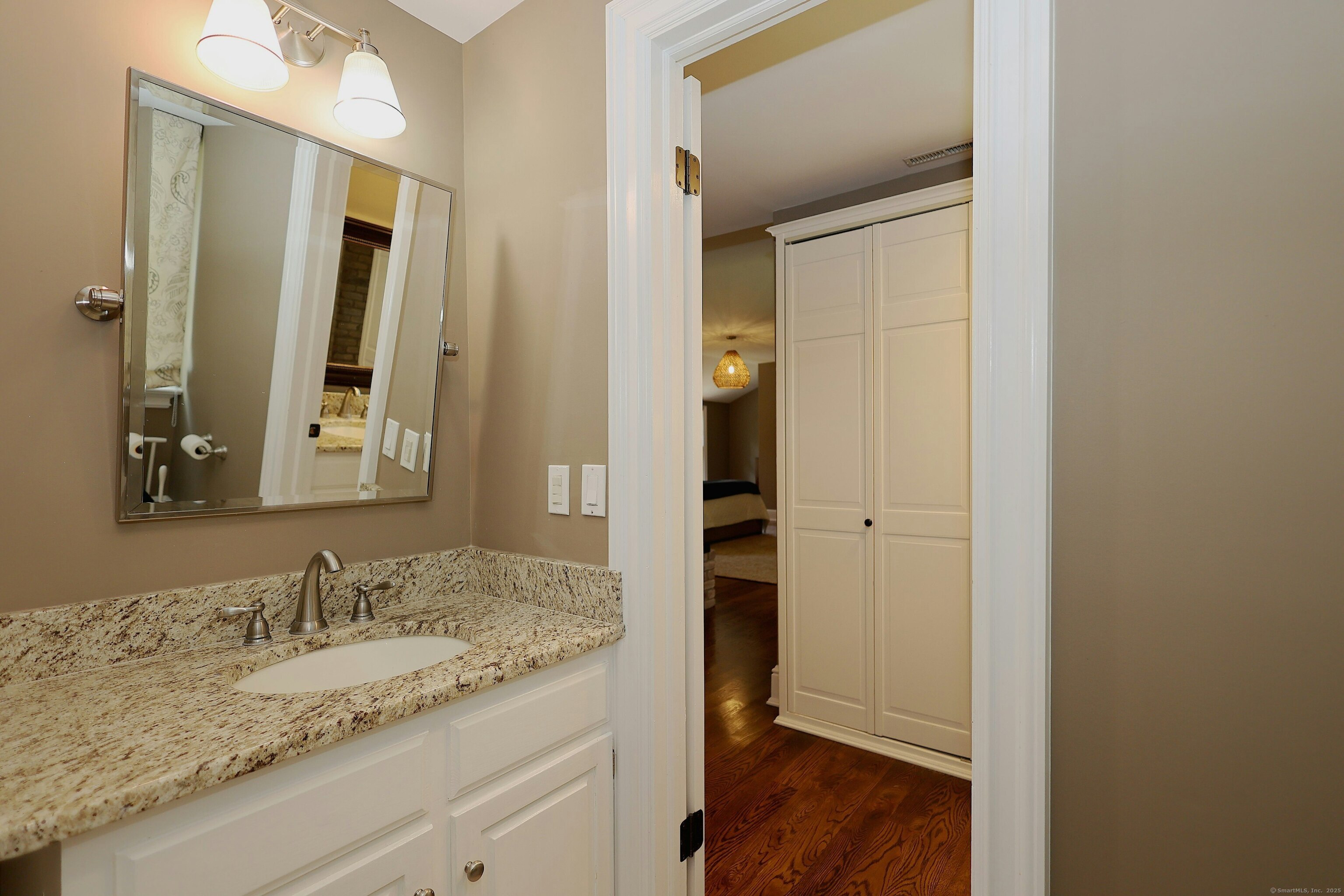 112 Middlebrook Farm Road Wilton, CT 06897 - Photo 32 of 40 a bathroom with a granite countertop sink and a mirror