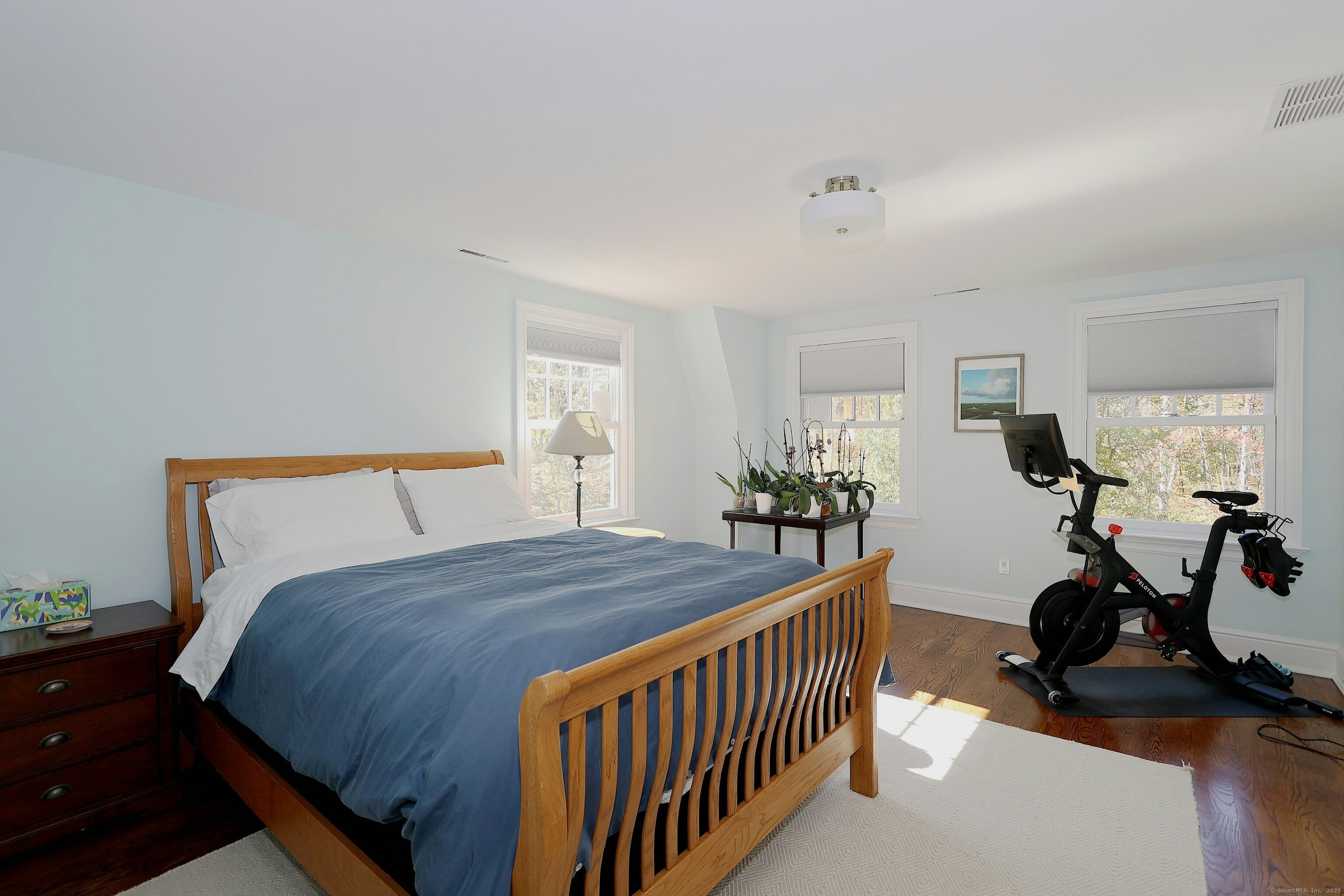 112 Middlebrook Farm Road Wilton, CT 06897 - Photo 36 of 40 a bedroom with a bed and a wooden floor