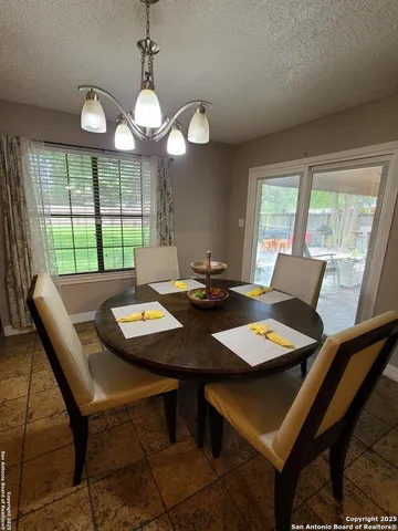 a view of a dining room with furniture and window