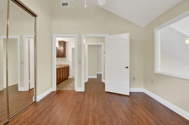 a view of a hallway with wooden floor