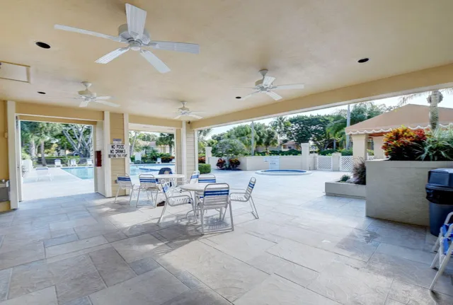 a view of a patio with dining table and chairs