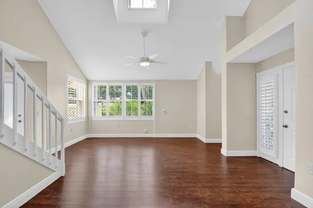 wooden floor in an empty room with a window