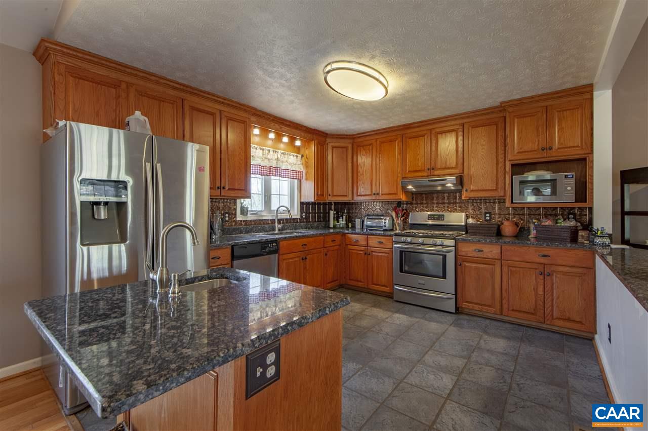 203 Quail Run Amherst, VA 24521 - Photo 15 of 45 a kitchen with stainless steel appliances granite countertop a stove top oven a sink dishwasher a dining table and chairs with wooden floor