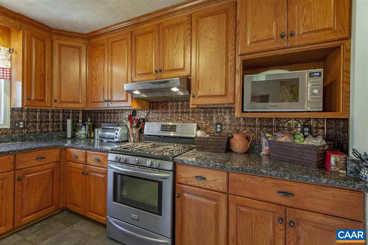 203 Quail Run Amherst, VA 24521 - Photo 16 of 45 a kitchen with granite countertop stainless steel appliances a stove microwave and cabinets
