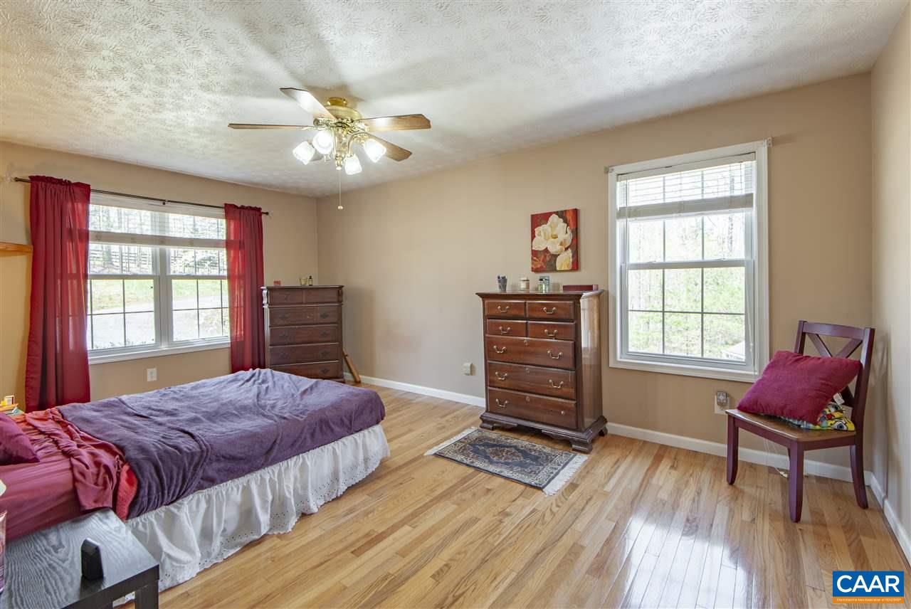 203 Quail Run Amherst, VA 24521 - Photo 19 of 45 a spacious bedroom with a bed and a window